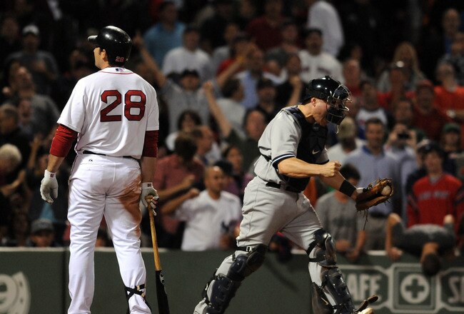 BOSTON, MA - SEPTEMBER 1: Catcher Russell Martin #55 of the New York Yankees pumps his fist after Adrian Gonzalez #28 of the Boston Red Sox strikes out to end the game at Fenway Park on September 1, 2011 in Boston, Massachusetts. The Yankees won the game 4-2. (Photo by Darren McCollester/Getty Images)