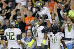 GLENDALE, AZ - JANUARY 10:  (R-L) LaMichael James #21 and Ramsen Golpashin #70 of the Oregon Ducks celebrate James' eight-yard touchdown reception in the second quarter against the Auburn Tigers during the Tostitos BCS National Championship Game at University of Phoenix Stadium on January 10, 2011 in Glendale, Arizona.  (Photo by Kevin C. Cox/Getty Images)