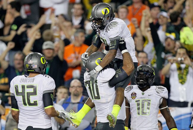 GLENDALE, AZ - JANUARY 10:  (R-L) LaMichael James #21 and Ramsen Golpashin #70 of the Oregon Ducks celebrate James' eight-yard touchdown reception in the second quarter against the Auburn Tigers during the Tostitos BCS National Championship Game at University of Phoenix Stadium on January 10, 2011 in Glendale, Arizona.  (Photo by Kevin C. Cox/Getty Images)