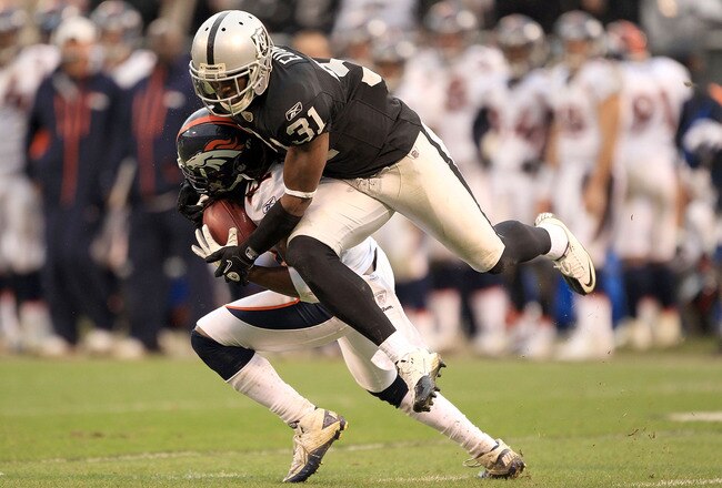 OAKLAND, CA - DECEMBER 19:  Syd'Quan Thompson #22 of the Denver Broncos is tackled by Hiram Eugene #31 of the Oakland Raiders at Oakland-Alameda County Coliseum on December 19, 2010 in Oakland, California.  (Photo by Ezra Shaw/Getty Images)