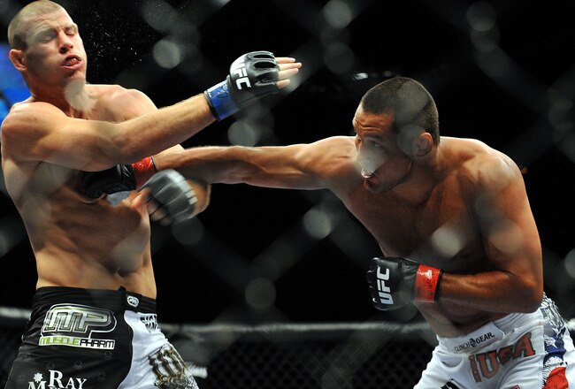 LAS VEGAS - JULY 11:  (R-L) Dan Henderson connects with a right to Mike Bisping during their middleweight bout during UFC 100 on July 11, 2009 in Las Vegas, Nevada.  (Photo by Jon Kopaloff/Getty Images)