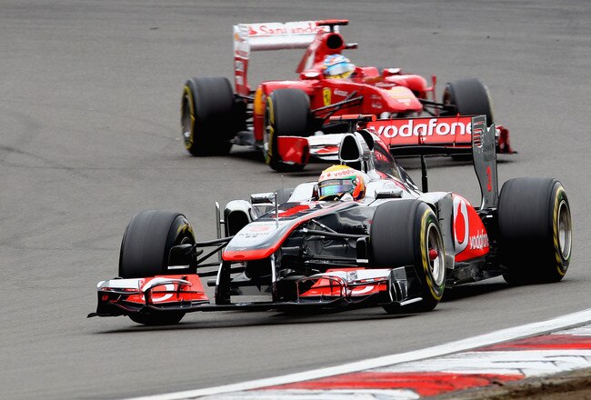 NUERBURG, GERMANY - JULY 24:  Race winner Lewis Hamilton of Great Britain and McLaren leads from second placed Fernando Alonso of Spain and Ferrari during the German Formula One Grand Prix at the Nurburgring on July 24, 2011 in Nuerburg, Germany.  (Photo by Clive Mason/Getty Images)
