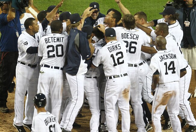 DETROIT, MI - SEPTEMBER 03:  Miguel Cabrera #24 of the Detroit Tigers is swarmed by teammates after hitting a walk off, solo homerun in the bottom of the ninth inning to win the game at 9-8 against the Chicago White Sox at Comerica Park on September 3, 2011 in Detroit, Michigan. The Tigers won 9-8  (Photo by Dave Reginek/Getty Images)