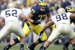 ANN ARBOR, MI - SEPTEMBER 15:  Jake Long #77 of the Michigan Wolverines gets ready to pass block against Joe Brockington #52 and Trevor Laws #98 of the Notre Dame Fighting Irish at Michigan Stadium September 15, 2007 in Ann Arbor, Michigan.  (Photo by Gregory Shamus/Getty Images)