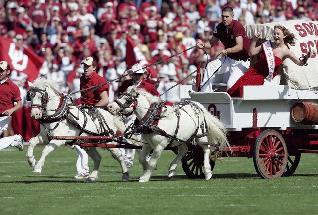 NORMAN, OK - OCTOBER 2:  Horses lead the Oklahoma Sooner Schooner across the field before the football game against Texas Tech Red Raiders on October 2, 2004 at Memorial Stadium in Norman, Oklahoma.  The Sooners defeated the Red Raiders  28-13.  (Photo by Brian Bahr/Getty Images)