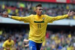 LONDON, ENGLAND - MARCH 27: Neymar of Brazil celebrates scoring the opening goal during the International friendly match between Brazil and Scotland at Emirates Stadium on March 27, 2011 in London, England.  (Photo by Jamie McDonald/Getty Images)