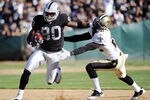 OAKLAND, CA - AUGUST 28:  Derek Hagan #80 of the Oakland Raiders stiff arms Tracy Porter #22 of the New Orleans Saints and runs thirty five yards for a touchdown in the first quarter during an NFL pre-season football game at the O.co Coliseum August 28, 2011 in Oakland, California. (Photo by Thearon W. Henderson/Getty Images)