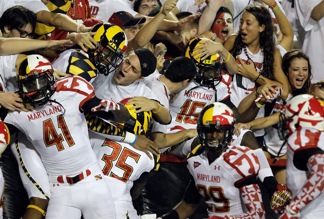 COLLEGE PARK, MD - SEPTEMBER 05: Members of the Maryland Terrapins jump into the student section before the start of the Terrapins game against the Miami Hurricanes at Byrd Stadium on September 5, 2011 in College Park, Maryland.  (Photo by Rob Carr/Getty Images)