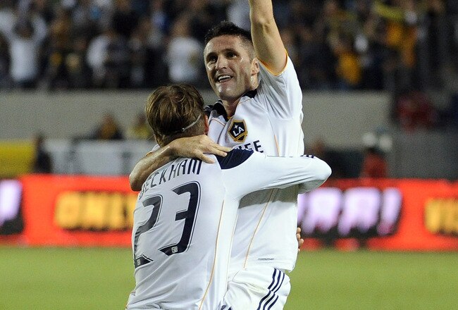 CARSON, CA - AUGUST 20:  Robbie Keane #14 of the Los Angeles Galaxy celebrates his goal in his debut game with teammate David Beckkham #23 for a 1-0 lead over the San Jose Earthquakes during the frist half at The Home Depot Center on August 20, 2011 in Carson, California.  (Photo by Harry How/Getty Images)