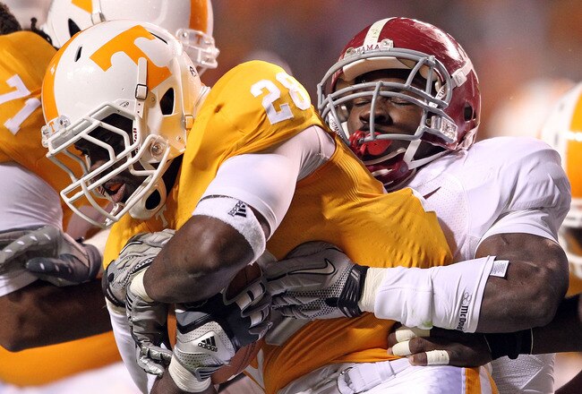KNOXVILLE, TN - OCTOBER 23:  Tauren Poole #28 of the Tennessee Volunteers runs with the ball dwhile tackled by C.J. Mosley #32 of the Alabama Crimson Tide at Neyland Stadium on October 23, 2010 in Knoxville, Tennessee.  (Photo by Andy Lyons/Getty Images)
