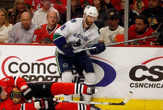 CHICAGO - MAY 03: Brent Sopel #5 of the Chicago Blackhawks falls to ice while trying to knock the puck away from Pavol Demitra #38 of the Vancouver Canucks in Game Two of the Western Conference Semifinals during the 2010 NHL Stanley Cup Playoffs at United Center on May 3, 2010 in Chicago, Illinois. The Blackhawks defeated the Canucks 4-2. (Photo by Jonathan Daniel/Getty Images)