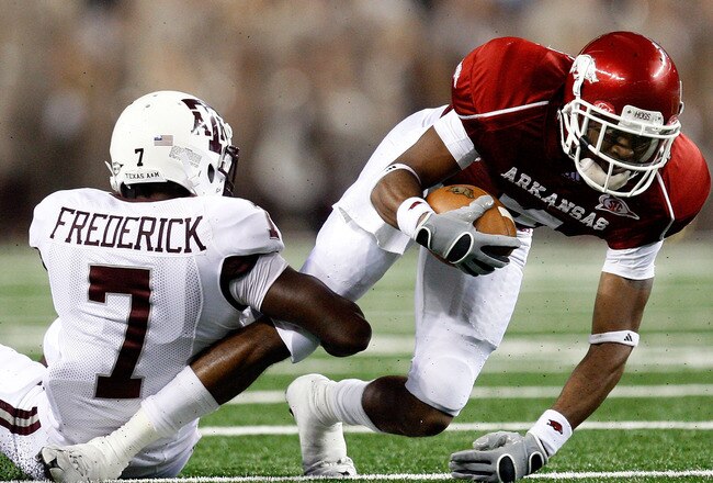 ARLINGTON, TX - OCTOBER 03:  Wide receiver Jarius Wright #4 of the Arkansas Razorbacks is tackled by Terrence Frederick #7 of the Texas A&M Aggies at Dallas Cowboys Stadium on October 3, 2009 in Arlington, Texas.  (Photo by Ronald Martinez/Getty Images)
