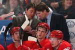 DETROIT - FEBRUARY 4:  (L-R) Assistant Coach Brad McCrimmon and Head Coach Mike Babcock of the Detroit Red Wings confer behind the players on the bench during the NHL game against the Phoenix Coyotes at Joe Louis Arena on February 4, 2009 in Detroit, Michigan. The Red Wings defeated the Coyotes 5-4.  (Photo By Dave Sandford/Getty Images)
