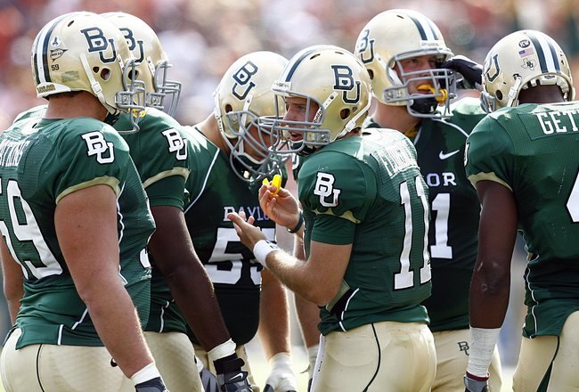 WACO, TX - NOVEMBER 14:  Quarterback Nick Florence #11 of the Baylor Bears leads his team in the huddle against the Texas Longhorns in the second half on November 14, 2009 at Floyd Casey Stadium in Waco, Texas. (Photo by Tom Pennington/Getty Images)