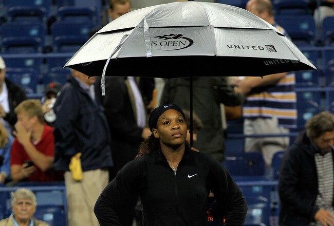 NEW YORK, NY - SEPTEMBER 07: Serena Williams of the United States sits under an umbrella during a rain delay prior playing against  Anastasia Pavlyuchenkova of Russia on Day Ten of the 2011 US Open at the USTA Billie Jean King National Tennis Center on September 7, 2011 in the Flushing neighborhood of the Queens borough of New York City.  (Photo by Chris Trotman/Getty Images)