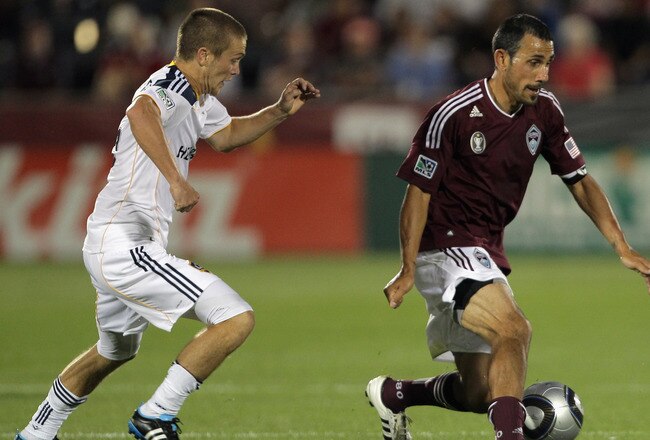 COMMERCE CITY, CO - JUNE 18:  Pablo Mastroeni #25 of the Colorado Rapids controls the ball against Michael Stephens #26 and Omar Gonzalez #4 of the Los Angeles Galaxy at Dick's Sporting Goods Park on June 18, 2011 in Commerce City, Colorado. The Galaxy defeated the Rapids 3-1.  (Photo by Doug Pensinger/Getty Images)