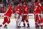 DETROIT - MAY 10: Jimmy Howard #35 of the Detroit Red Wings celebrates a 3-1 victory with teammates over the San Jose Sharks in Game Six of the Western Conference Semifinals during the 2011 NHL Stanley Cup Playoffs on May 10, 2011 at Joe Louis Arena in Detroit, Michigan. (Photo by Gregory Shamus/Getty Images)