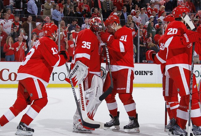 DETROIT - MAY 10: Jimmy Howard #35 of the Detroit Red Wings celebrates a 3-1 victory with teammates over the San Jose Sharks in Game Six of the Western Conference Semifinals during the 2011 NHL Stanley Cup Playoffs on May 10, 2011 at Joe Louis Arena in Detroit, Michigan. (Photo by Gregory Shamus/Getty Images)