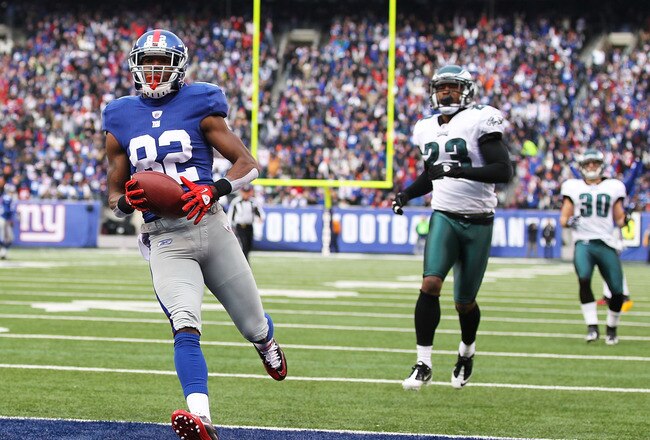 EAST RUTHERFORD, NJ - DECEMBER 19:  Mario Manningham #82 of the New York Giants scores a touchdown in the first quarter as Dimitri Patterson #23 and Colt Anderson #30 of the Philadelphia Eagles defend during their game on December 19, 2010 at The New Meadowlands Stadium in East Rutherford, New Jersey.  (Photo by Al Bello/Getty Images)