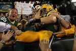 GREEN BAY, WI - SEPTEMBER 08: John Kuhn #30 of the Green Bay Packers leaps into the stands after scoring a touchdown against the New Orleans Saints during the NFL opening season game at Lambeau Field on September 8, 2011 in Green Bay, Wisconsin. (Photo by Jonathan Daniel/Getty Images)