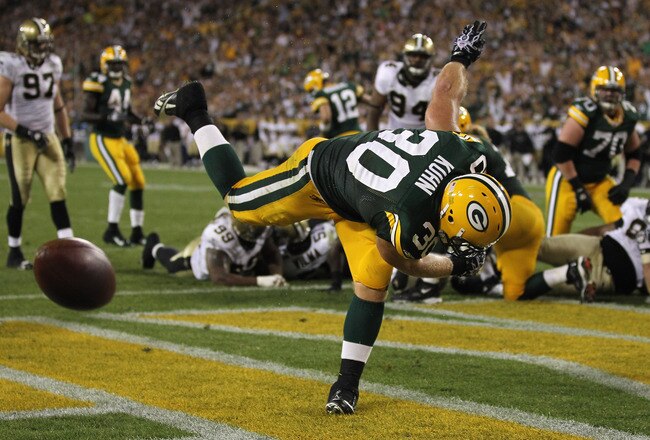 GREEN BAY, WI - SEPTEMBER 08:  John Kuhn #30 of the Green Bay Packers spikes the ball after scoring a touchdown against the New Orleans Saints during the NFL opening season game at Lambeau Field on September 8, 2011 in Green Bay, Wisconsin.  (Photo by Jonathan Daniel/Getty Images)