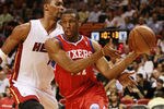 MIAMI, FL - MARCH 25:  Forward Thaddeus Young #21 of the Philadelphia Sixers drives against Forward Chris Bosh #1 of the Miami Heat at American Airlines Arena on March 25, 2011 in Miami, Florida. The Heat defeated the Sixers 111-99. NOTE TO USER: User expressly acknowledges and agrees that, by downloading and/or using this Photograph, User is consenting to the terms and conditions of the Getty Images License Agreement.  (Photo by Marc Serota/Getty Images)