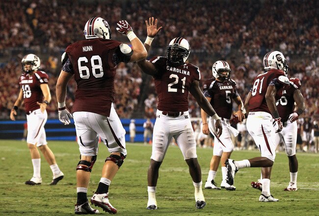 CHARLOTTE, NC - SEPTEMBER 03:  Marcus Lattimore #21 of the South Carolina Gamecocks celebrates with teammate Kyle Nunn #68 after a touchdown during their game against the East Carolina Pirates at Bank of America Stadium on September 3, 2011 in Charlotte, North Carolina.  (Photo by Streeter Lecka/Getty Images)