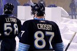 PITTSBURGH, PA - JANUARY 01:  Sidney Crosby #87 of the Pittsburgh Penguins walks off the ice with teammates after being defeated 3-1 by the Washington Capitals during the 2011 NHL Bridgestone Winter Classic at Heinz Field on January 1, 2011 in Pittsburgh, Pennsylvania.  (Photo by Jamie Squire/Getty Images)