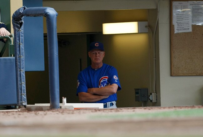 MILWAUKEE, WI - JULY 28: Mike Quade #8 of the Chicago Cubs looks on from the dugout against the Milwaukee Brewers at Miller Park on July 28, 2011 in Milwaukee, Wisconsin. (Photo by Scott Boehm/Getty Images)