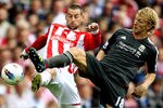 STOKE ON TRENT, ENGLAND - SEPTEMBER 10:  Rory Delap (L) of Stoke challenges DDirk Kuyt of Liverpool during the Barclays Premier League match between Stoke City and Liverpool at Britannia Stadium on September 10, 2011 in Stoke on Trent, England.  (Photo by Scott Heavey/Getty Images)