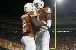AUSTIN, TX - SEPTEMBER 3:  Running back Fozzy Whittaker #2 and wide receiver John Harris #9 of the Texas Longhorns celebrate a fourth quarter touchdown against the Rice Owls on September 3, 2011 at Darrell K. Royal-Texas Memorial Stadium in Austin, Texas.  (Photo by Erich Schlegel/Getty Images)