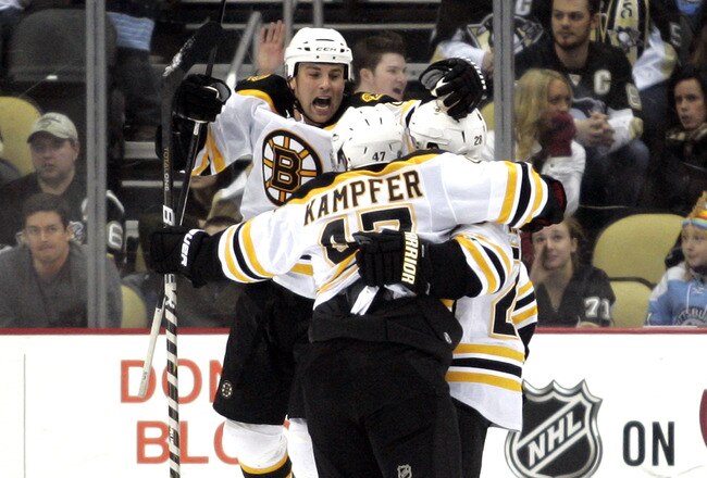 PITTSBURGH, PA - JANUARY 10:  Marc Savard #91 of the Boston Bruins celebrates a power play goal by Mark Recchi #28 against the Pittsburgh Penguins on January 10, 2011 at Consol Energy Center in Pittsburgh, Pennsylvania.  The Bruins defeated the Penguins 4-2.  (Photo by Justin K. Aller/Getty Images)