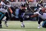 ST. LOUIS, MO - SEPTEMBER 11: Cadillac Williams #33 of the St. Louis Rams runs and pushes off of Cullen Jenkins #97 of the Philadelphia Eagles at the Edward Jones Dome on September 11, 2011 in St. Louis, Missouri. The Eagles defeated the Rams 31-15. (Photo by Jeff Curry/Getty Images)