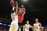 TULSA, OK - MARCH 18:  John Holland #23 of the Boston University Terriers goes up for a shot against Thomas Robinson #0 of the Kansas Jayhawks during the second round of the 2011 NCAA men's basketball tournament at BOK Center on March 18, 2011 in Tulsa, Oklahoma.  (Photo by Ronald Martinez/Getty Images)