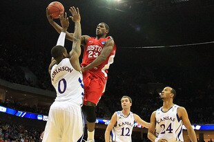 TULSA, OK - MARCH 18:  John Holland #23 of the Boston University Terriers goes up for a shot against Thomas Robinson #0 of the Kansas Jayhawks during the second round of the 2011 NCAA men's basketball tournament at BOK Center on March 18, 2011 in Tulsa, Oklahoma.  (Photo by Ronald Martinez/Getty Images)