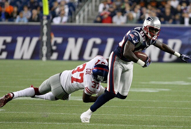FOXBORO, MA - SEPTEMBER 1:    Chad Ochocinco #85 of the New England Patriots gains yards against  Michael Coe #37 of the New York Giants at Gillette Stadium on September 1, 2011 in Foxboro, Massachusetts. (Photo by Jim Rogash/Getty Images)