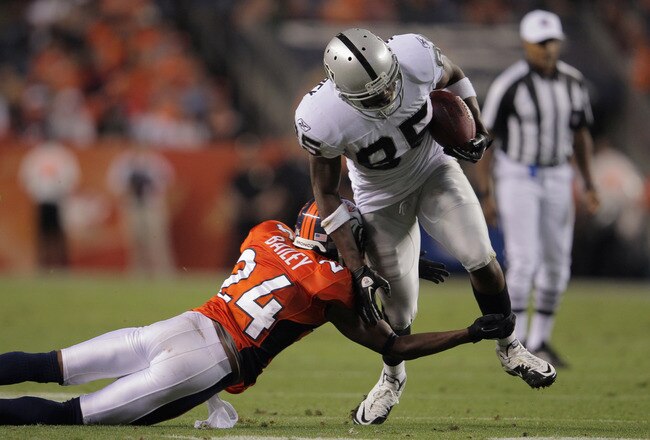 DENVER, CO - SEPTEMBER 12:  Wide reciever  Darrius Heyward-Bey #85 of the Oakland Raiders makes and  Champ Bailey #24 of the Denver Broncos makes the tackle at Sports Authority Field at Mile High on September 12, 2011 in Denver, Colorado.  (Photo by Doug Pensinger/Getty Images)