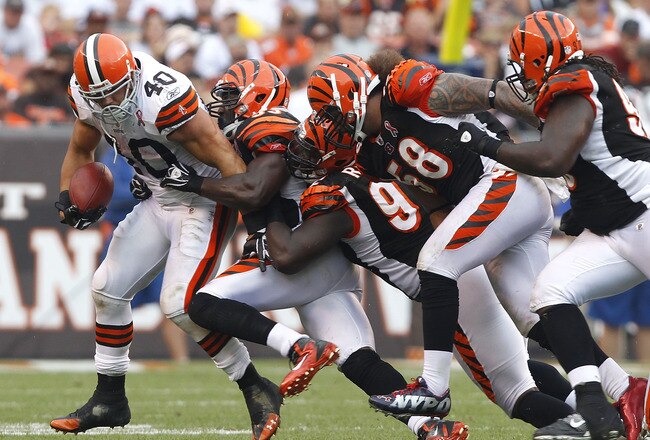 CLEVELAND, OH - SEPTEMBER 11:  Running back Peyton Hillis #40 of the Cleveland Browns is tackled by defensive players of the Cincinnati Bengals during the season opener  at Cleveland Browns Stadium on September 11, 2011 in Cleveland, Ohio.  (Photo by Matt Sullivan/Getty Images)