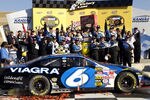 KANSAS CITY, KS - OCTOBER 9:  Mark Martin, driver of the #6 Viagra Ford, celebrates with his team after winning the NASCAR Nextel Cup Series Banquet 400 on October 9, 2005 at the Kansas Speedway in Kansas City, Kansas.  (Photo by Rusty Jarrett/Getty Images)