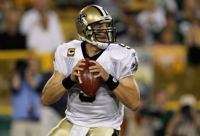 GREEN BAY, WI - SEPTEMBER 08:   Drew Brees #9 of the New Orleans Saints looks to pass against the Green Bay Packers during the season opening game at Lambeau Field on September 8, 2011 in Green Bay, Wisconsin.  (Photo by Jonathan Daniel/Getty Images)