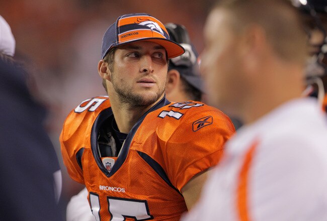 DENVER, CO - SEPTEMBER 12:  Quarterback  Tim Tebow #15 of the Denver Broncos looks on from the bench against the Oakland Raiders at Sports Authority Field at Mile High on September 12, 2011 in Denver, Colorado. The Raiders defeated the Broncos 23-20.  (Photo by Doug Pensinger/Getty Images)