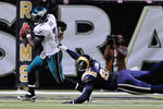 ST. LOUIS, MO - SEPTEMBER 11: Michael Vick #7 of the Philadelphia Eagles scrambles as Chris Long #91 of the St. Louis Rams dives for him at the Edward Jones Dome on September 11, 2011 in St. Louis, Missouri. The Eagles defeated the Rams 31-15. (Photo by Jeff Curry/Getty Images)