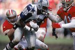SAN FRANCISCO - JANUARY 15:  Wide receiver Michael Irvin #88 of the Dallas Cowboys gets tackled during the 1994 NFC Conference Championship game against the San Francisco 49ers at Candlestick Park on January 15, 1995 in San Francisco, California.  The 49ers won 38-28.  (Photo by George Rose/Getty Images)