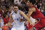 ATHENS - AUGUST 23:  Dimosthenis Ntikoudis of Greece attacks the ball in front of Peter John Ramos of Puerto Rico in the men's basketball preliminary game between Greece and Puerto Rico on August 23, 2004 during the Athens 2004 Summer Olympic Games at the Indoor Arena of the Helliniko Olympic Complex in Athens, Greece. (Photo by Stuart Hannagan/Getty Images)