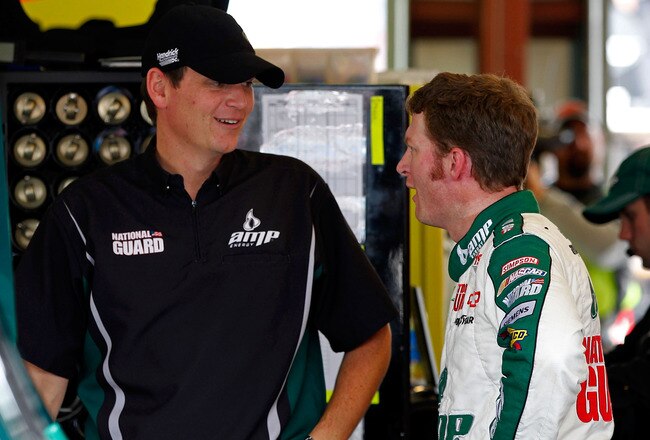 JOLIET, IL - SEPTEMBER 16:  Dale Earnhardt Jr. (R), driver of the #88 Amp Energy/National Guard Chevrolet, talks with crew chief Steve Letarte (L) in the garage during practice for the NASCAR Sprint Cup Series GEICO 400 at Chicagoland Speedway on September 16, 2011 in Joliet, Illinois.  (Photo by Geoff Burke/Getty Images for NASCAR)