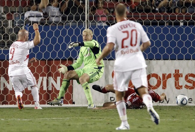 FRISCO, TX - SEPTEMBER 17: Joel Lindpere #20 of the New York Red Bulls watches as his teammate Luke Rodgers #9 shoots the ball past Kevin Hartman #1 and George John #14 of  the FC Dallas during the first half of a soccer game at Pizza Hut Park on September 17, 2011 in Frisco, Texas. (Photo by Brandon Wade/Getty Images)