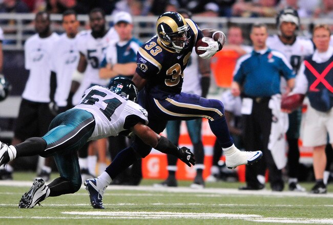 ST. LOUIS, MO - SEPTEMBER 11: Cadillac Williams #33 of the St. Louis Rams runs as Jamar Chaney #51 of the Philadelphia Eagles dives for a tackle at the Edward Jones Dome on September 11, 2011 in St. Louis, Missouri. The Eagles defeated the Rams 31-15. (Photo by Jeff Curry/Getty Images)
