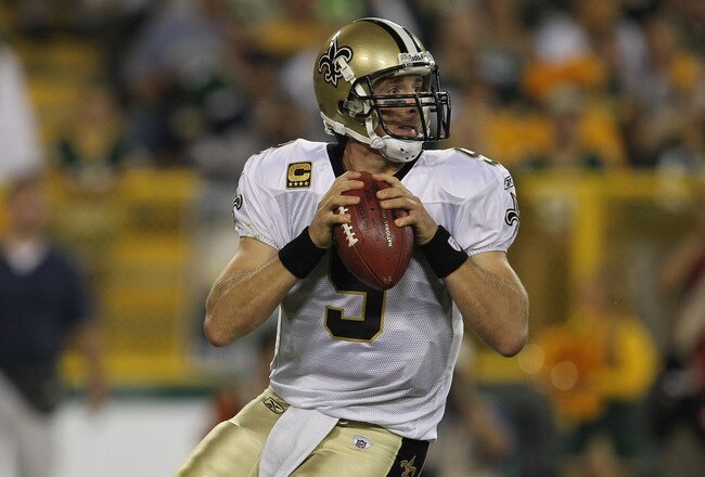 GREEN BAY, WI - SEPTEMBER 08:  Drew Brees #9 of the New Orleans Saints looks for a receiver against the Green Bay Packers during the NFL opening season game at Lambeau Field on September 8, 2011 in Green Bay, Wisconsin. The Packers defeated the Saints 42-34.  (Photo by Jonathan Daniel/Getty Images)