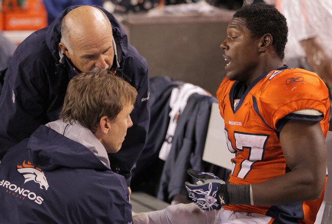DENVER, CO - SEPTEMBER 12:  Running back  Knowshon Moreno #27 of the Denver Broncos is attended to on the bench late in the fourth quarter against the Oakland Raiders at Sports Authority Field at Mile High on September 12, 2011 in Denver, Colorado. The Raiders defeated the Broncos 23-20.  (Photo by Doug Pensinger/Getty Images)