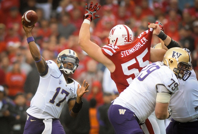 LINCOLN, NE - SEPTEMBER 17: Keith Price #17 of the Washington Huskies throws downfield over Baker Steinkuhler #55 of the Nebraska Cornhusker during their game at Memorial Stadium September 17, 2011 in Lincoln, Nebraska. Nebraska won 51-38.  (Photo by Eric Francis/Getty Images)